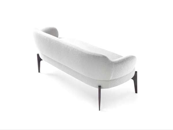 armchair, supported by sleek, sculpted legs.