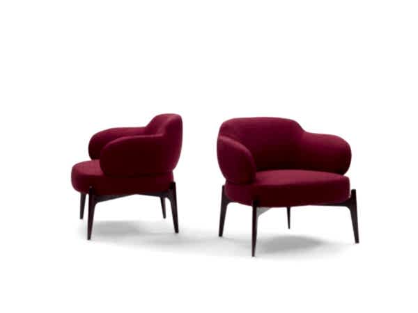 Elevate your interior with our designer armchair on artful legs, a true statement of contemporary living.