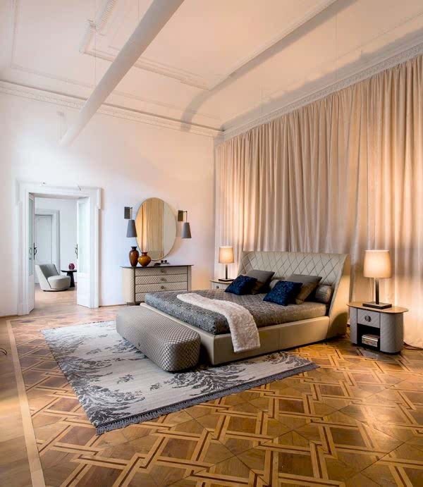 Elegant bed with a plush headboard featuring clean, vertical lines and a luxurious, tufted design for added comfort and style