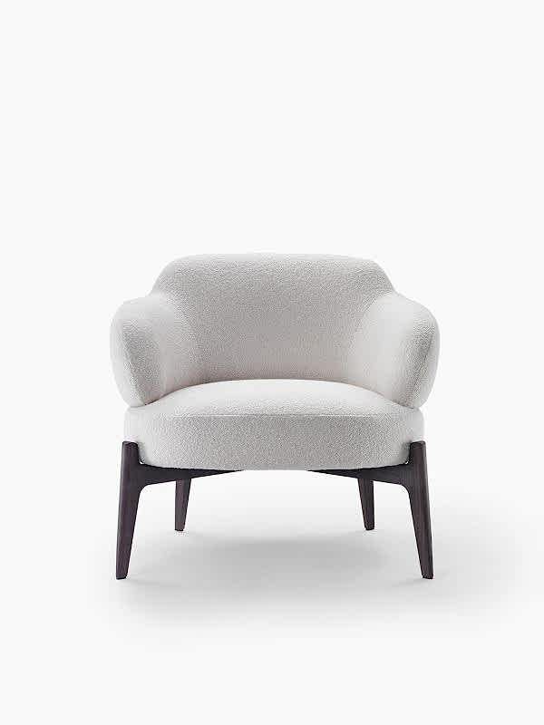 Transform your space into a masterpiece with our designer armchair, its legs a testament to fine craftsmanship.