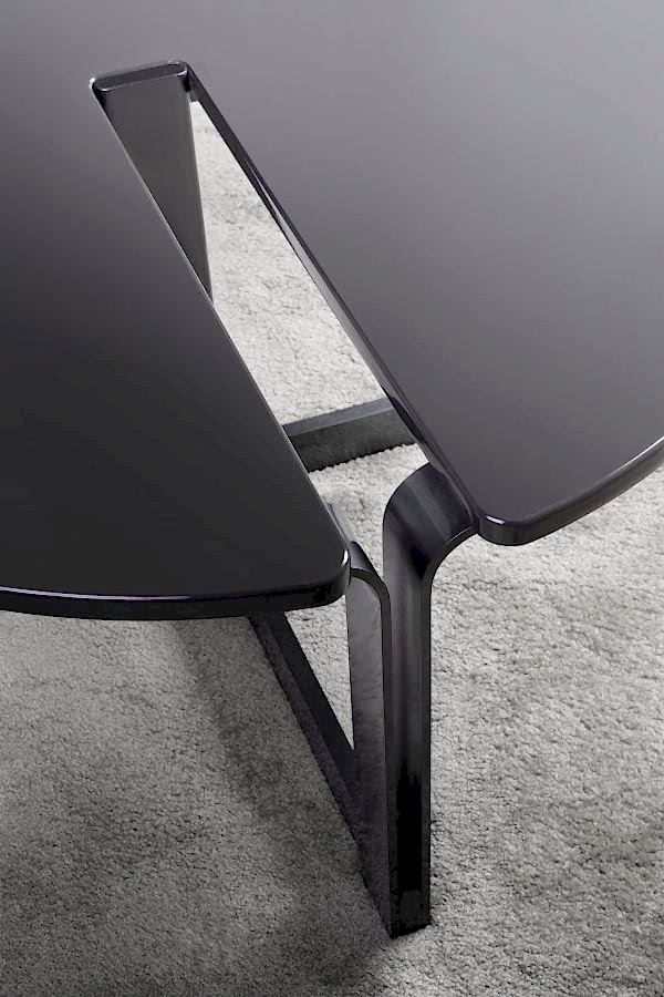The Cut-Out Coffee Table is a stunning and innovative piece that combines modern design with functional elements.